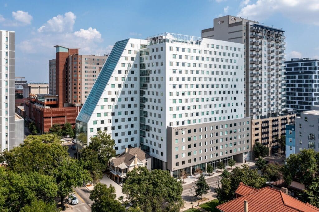 Side view of the student residence tower showing the balance between the historic house and modern facilities.