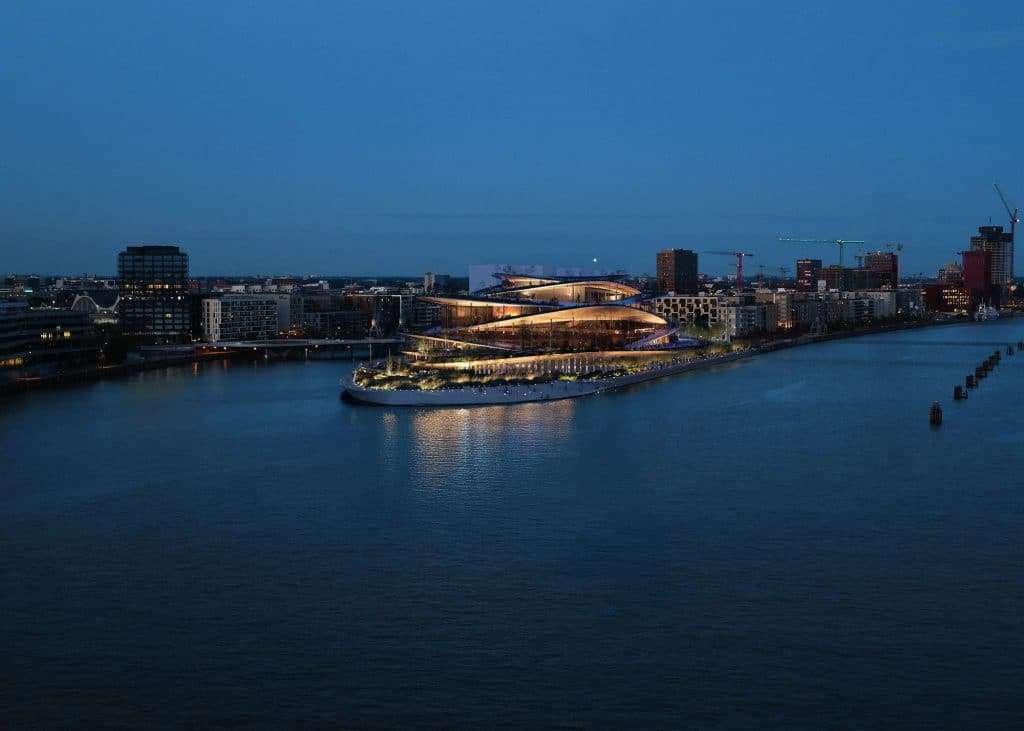 Hamburg State Opera illuminated at night, reflecting on surrounding waters