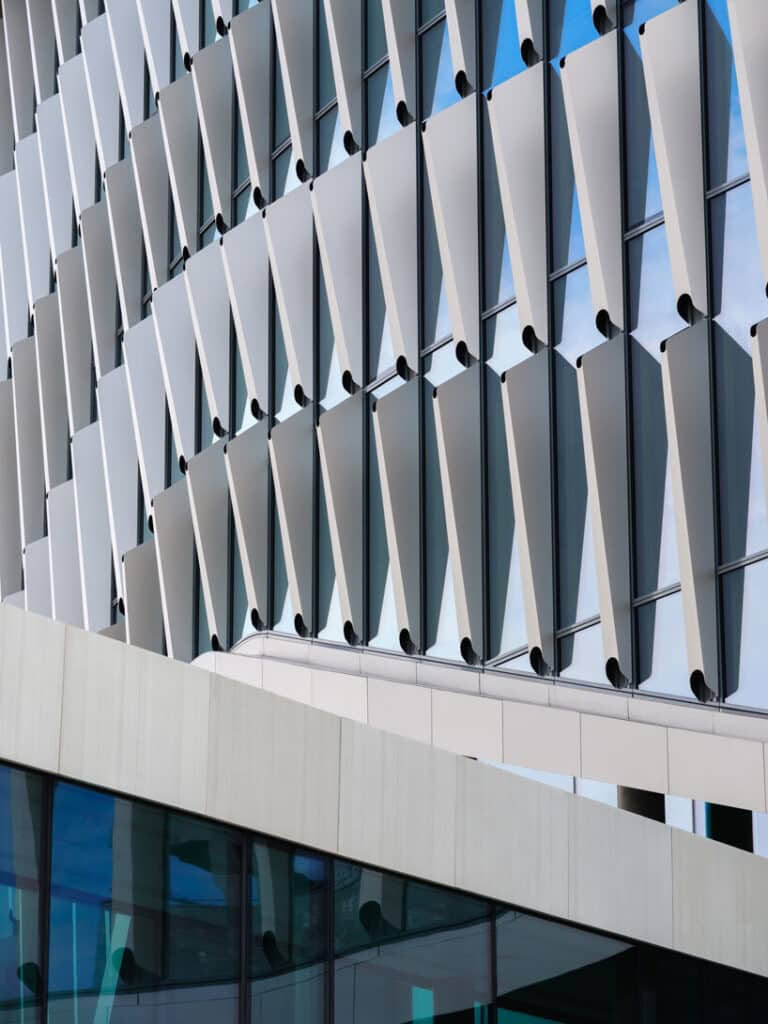 Close-up of facade’s precision, where light and shadow cast a dynamic geometric rhythm.