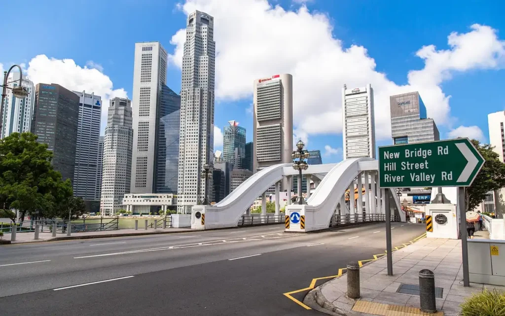 A graceful white bridge spans the river against Singapore&rsquo;s skyline  where urban design meets serenity.