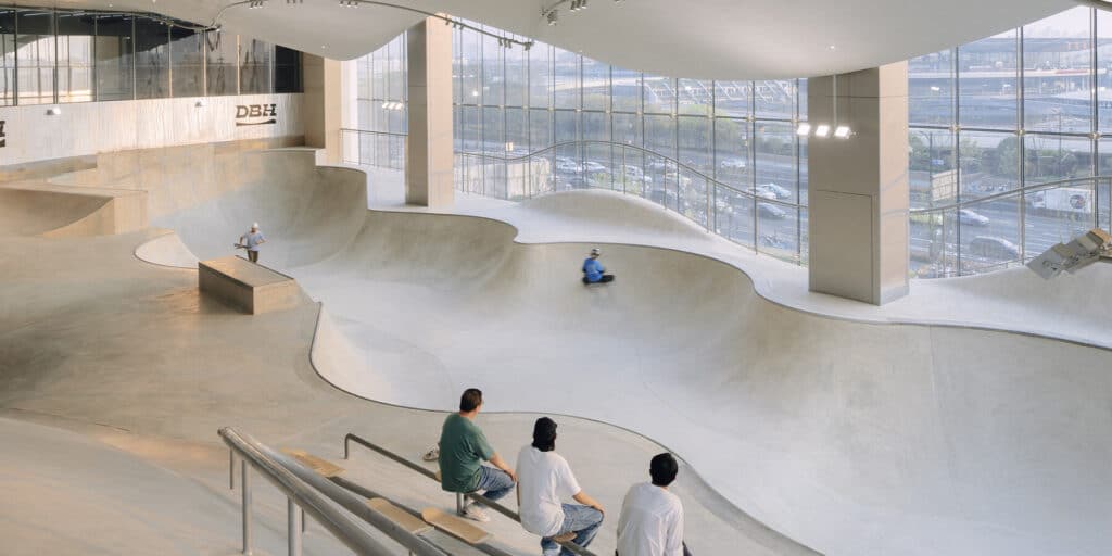 Dynamic ceiling and linear lighting harmonizing with the skatepark&rsquo;s curved floor surfaces