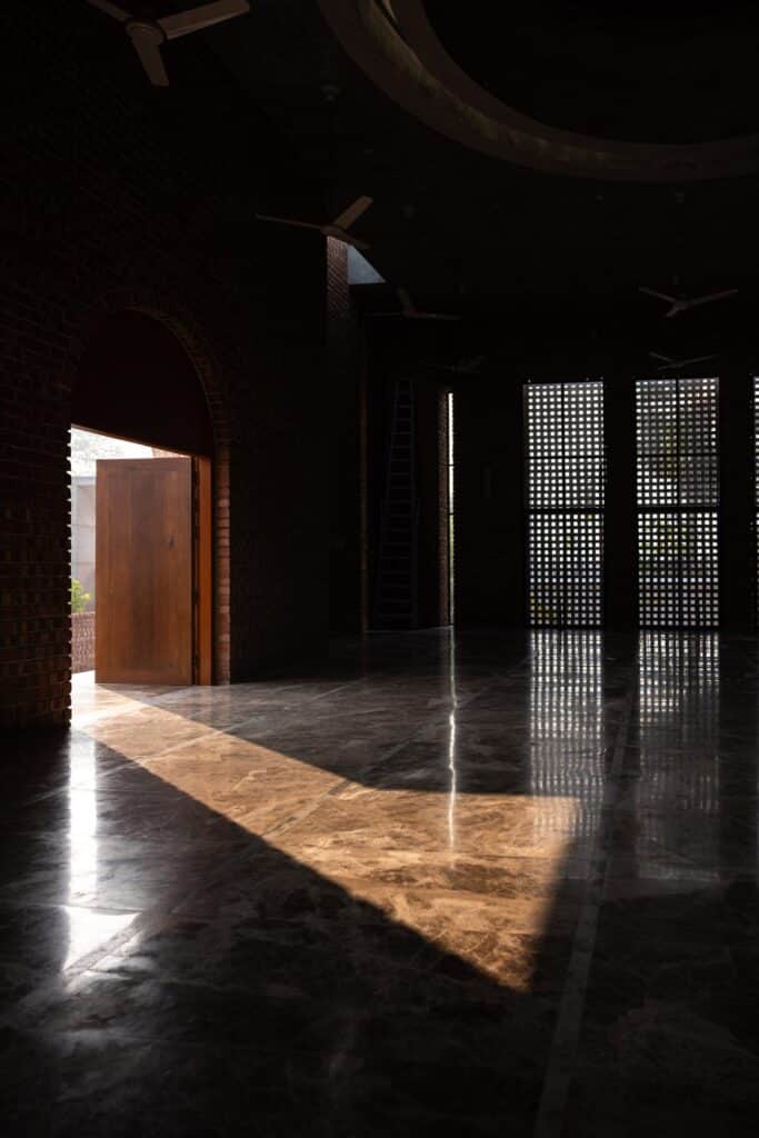 Interior view showcasing the mosque&rsquo;s clean lines and locally sourced heat-reflective materials.
