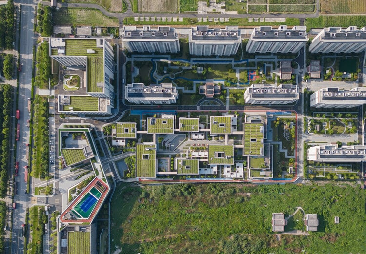 Elevated glass corridors connecting project units, overlooking gardens and interior spaces