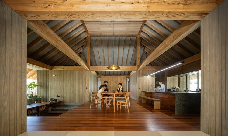 Exterior view focusing on the landscaped gardens and open spaces surrounding the house.