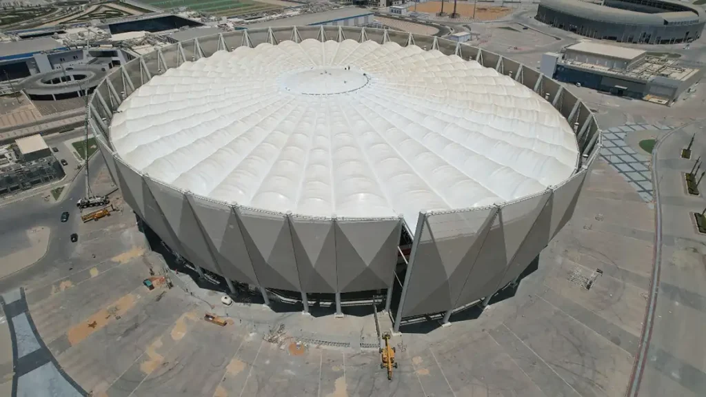 Aerial view of a white textile roof, echoing a desert tent’s form and scale.