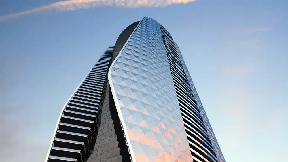Sleek glass facade catches the light, soaring skyward in architectural harmony.