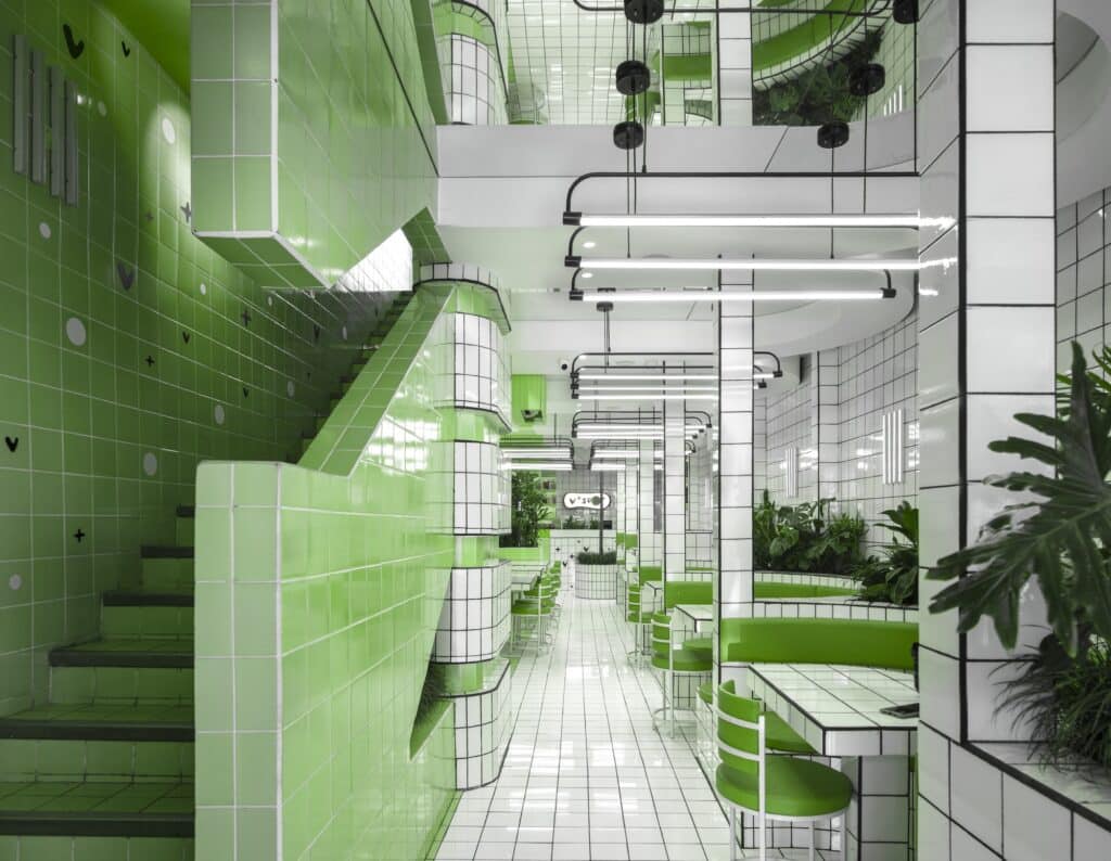 Modern vegan restaurant interior using green tones and natural materials