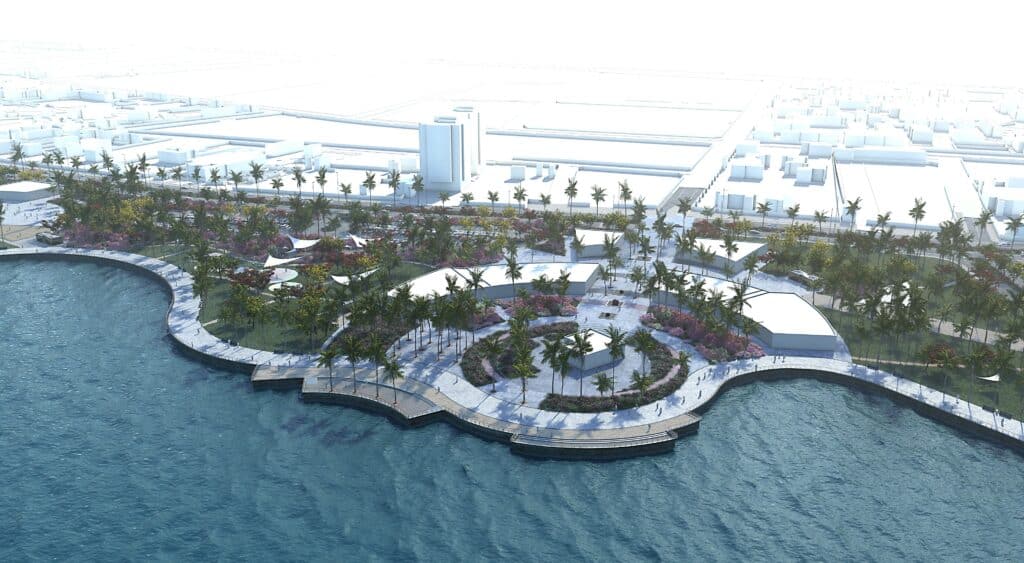 مسار ساحلي منحني ينساب بين البحر والمساحات الخضراء