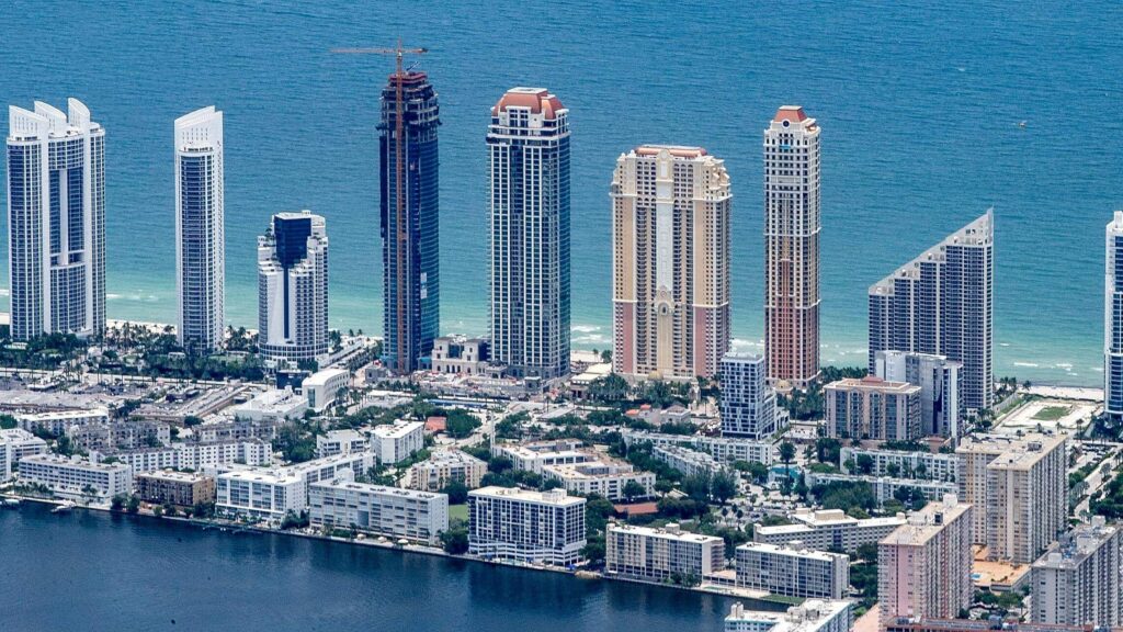 Coastal skyline of towers meets the sea, where modernity and nature blend in harmony.