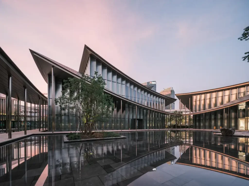 Expansive front plaza of the museum with views of landscaped gardens extending toward Jinji Lake.