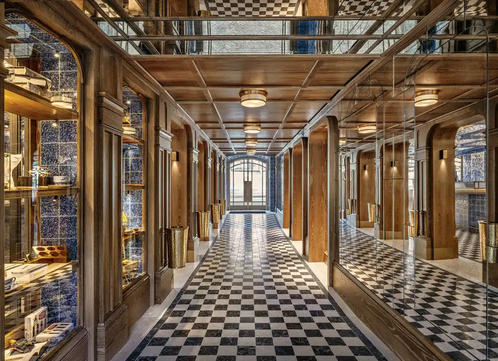  Long corridor with wooden ceiling, checkered floor, blue tiles, and mirrored walls reflecting every detail.