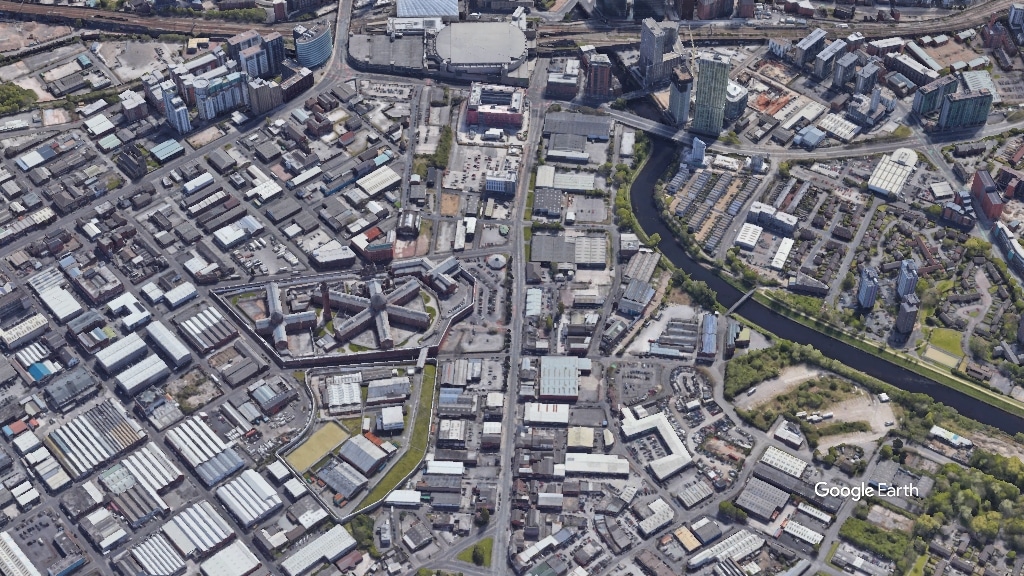 Aerial view of the Strangeways Cambridge site showing the overall urban layout and green spaces integrated with buildings.
