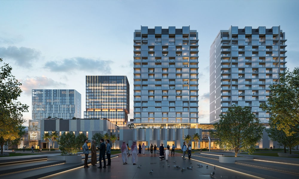 Modern residential towers in Miraf District, Khobar illuminated walkways and open plazas create a lively urban hub at dusk.