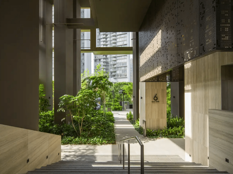 Marble entrance embraced by lush greenery, welcoming visitors with calm and warmth.