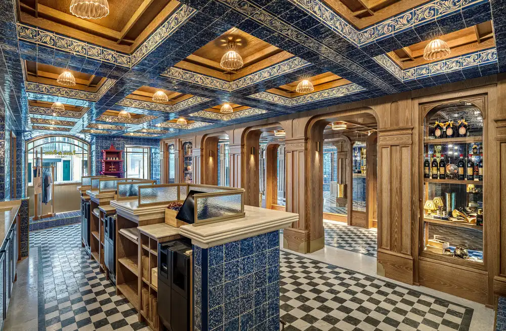 Ornate blue-tiled ceiling, checkered floor, and wooden counter the heart of the expansion.