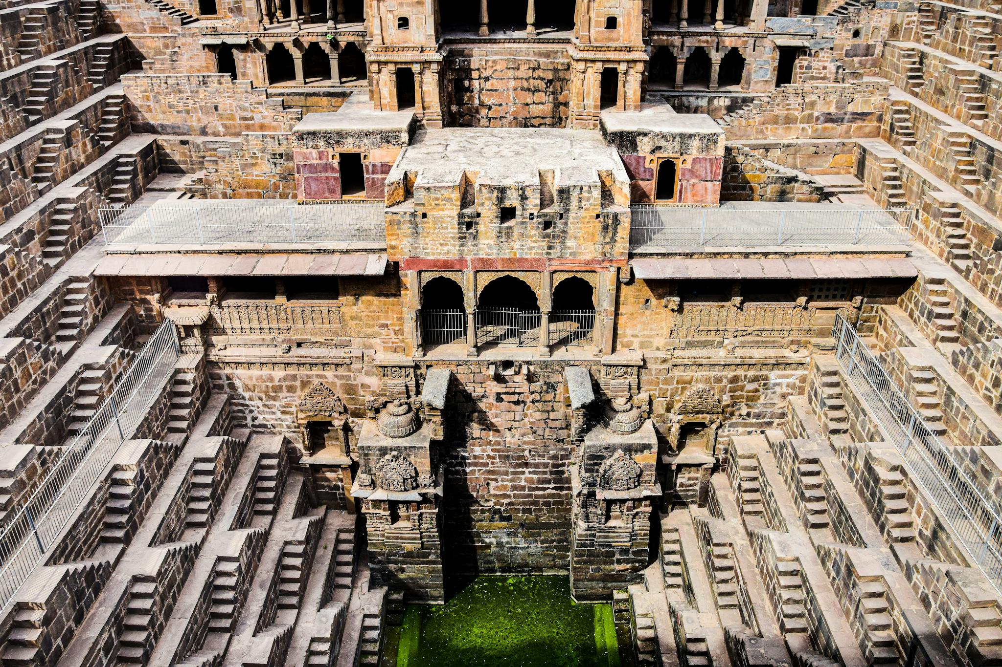 A mesmerizing view of an ancient Indian stepwell showcasing stunning symmetry and intricate stone work.