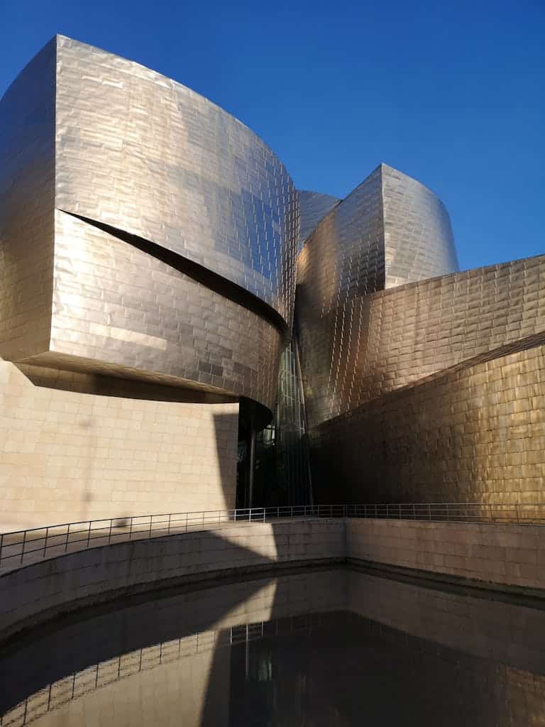 Captivating view of the Guggenheim Museum Bilbao with its modern architectural style reflecting in water.