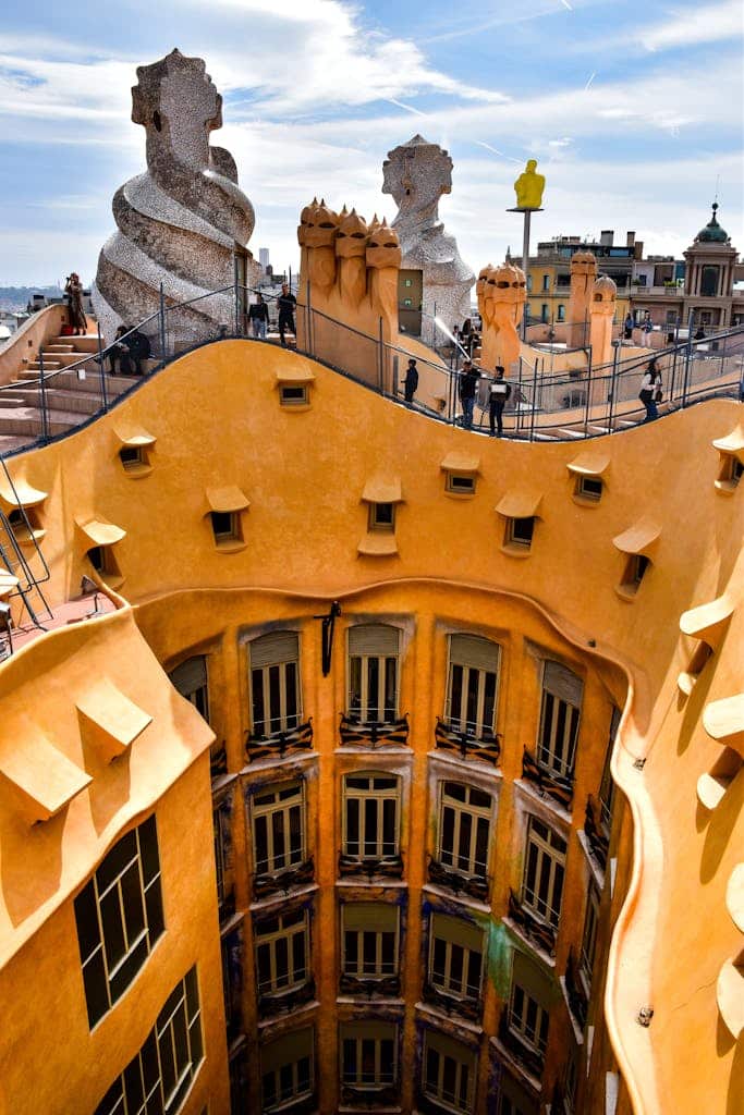 Explore the intricate rooftop of Casa Mil&agrave;, a Gaud&iacute; masterpiece in Barcelona, with its stunning chimneys and views.