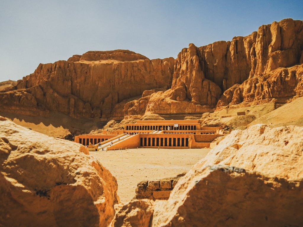 Explore the majestic Hatshepsut Temple nestled in the rocky desert landscape of Luxor, Egypt.