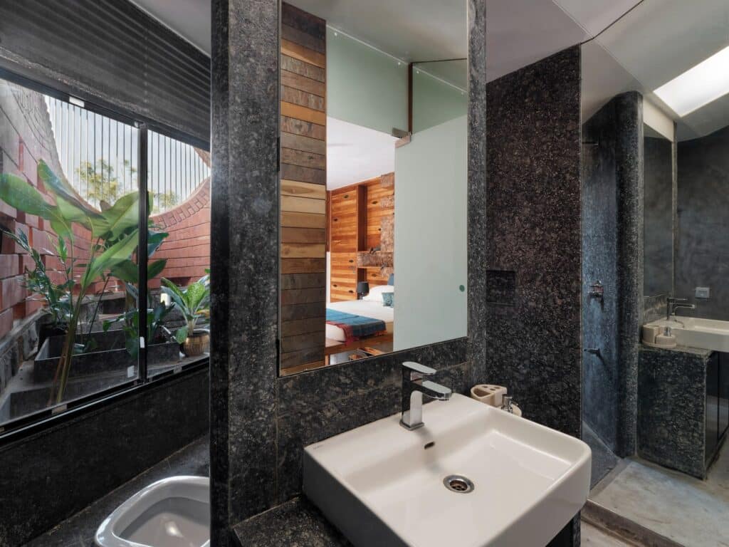 Maratha Sardar heritage house integrating traditional 'Wada' architecture with modern design, sustainable features, and self-sufficient living spaces.