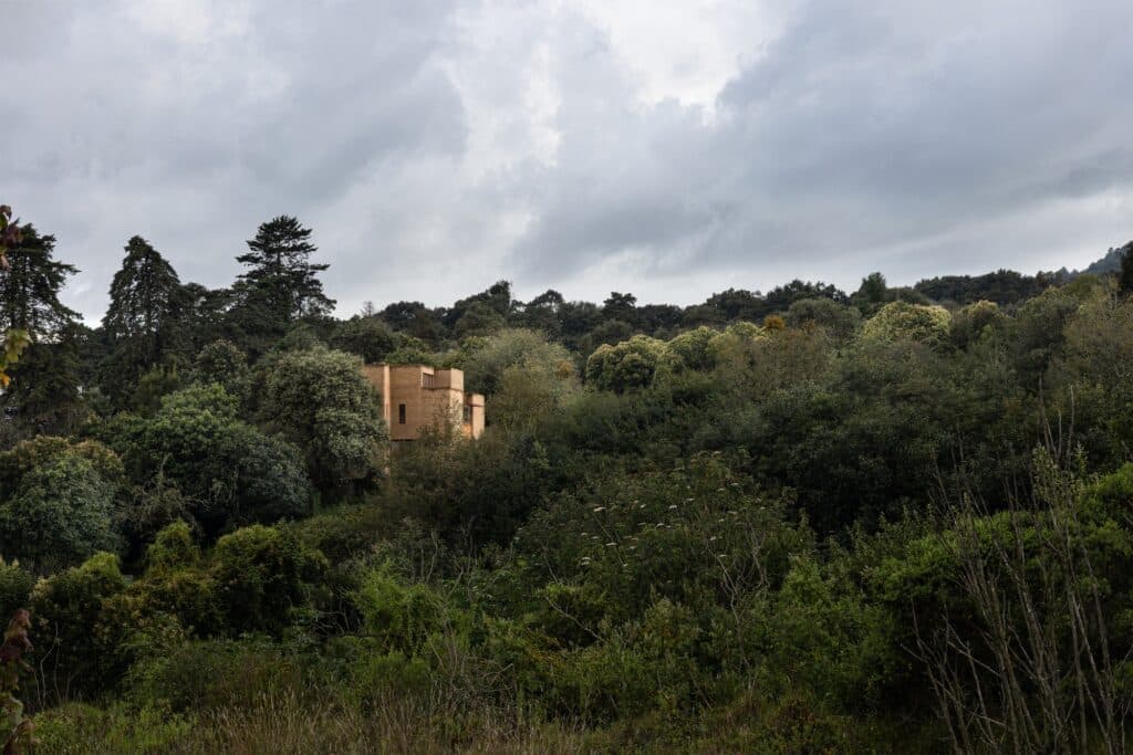 Casa La Sierra, an architectural project in the Huayutipac forest, exemplifies sustainable design by integrating the building with natural slopes, local materials, split-level interiors, and suspended transitional spaces, creating a dialogue between architecture and nature.