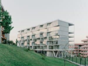 Lisi Garden House seven-story modular building with stacked units and integrated terraces overlooking Tbilisi's landscape.