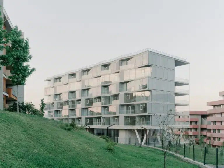 Lisi Garden House seven-story modular building with stacked units and integrated terraces overlooking Tbilisi's landscape.