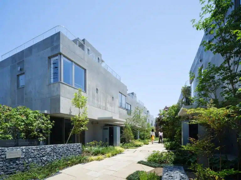 Overview of Nishi-Ogikubo residential cluster showing three-story terraced houses and narrow garden paths.