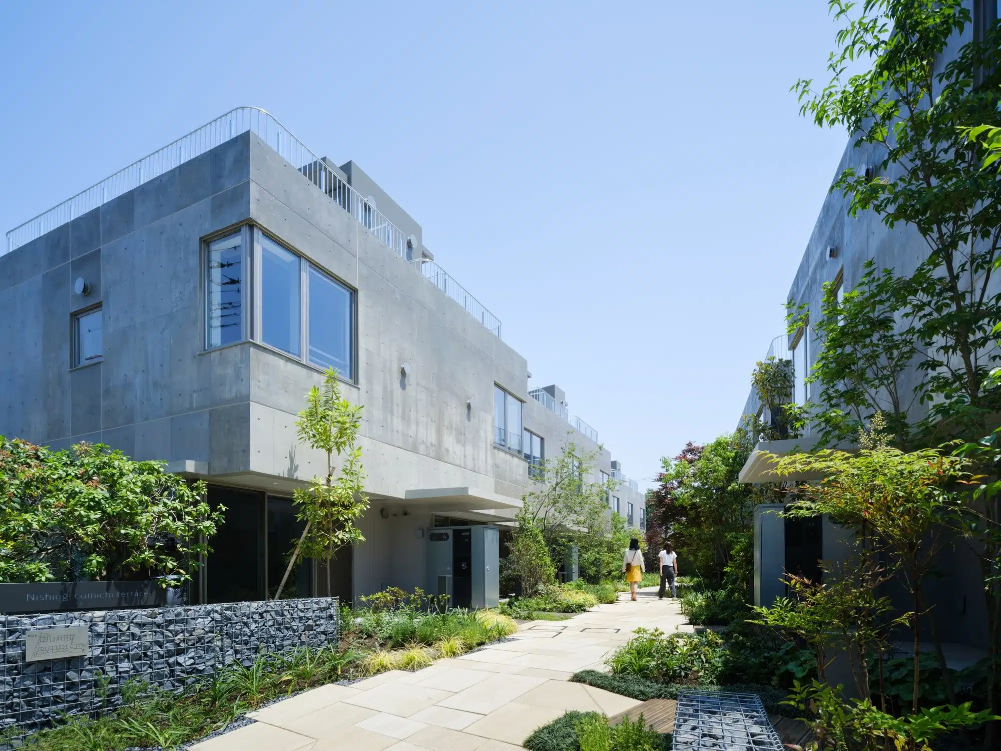 Overview of Nishi-Ogikubo residential cluster showing three-story terraced houses and narrow garden paths.