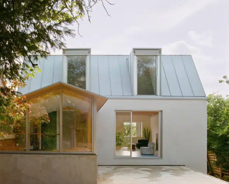 Comprehensive view of the renovated 1980s house showing sustainable upgrades, improved energy efficiency, open interior spaces, and enhanced natural lighting and ventilation