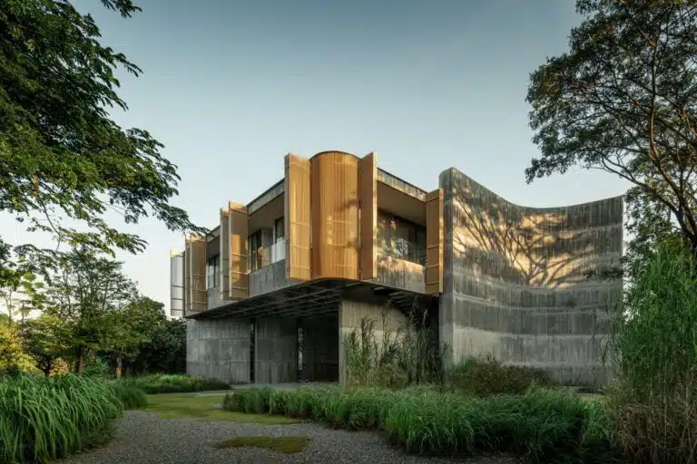 Exterior view of W House II showing the elevated single-story structure and its integration with the surrounding natural landscape.