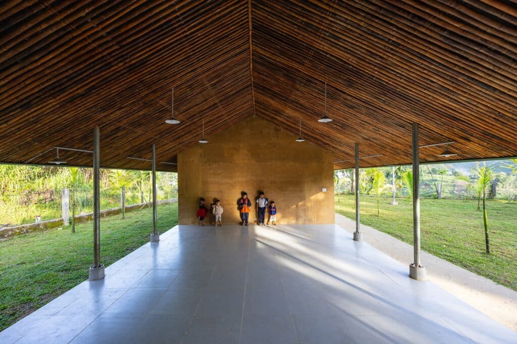 Central courtyard of Nuoc Ui School offering panoramic valley views and connection with surrounding forests.