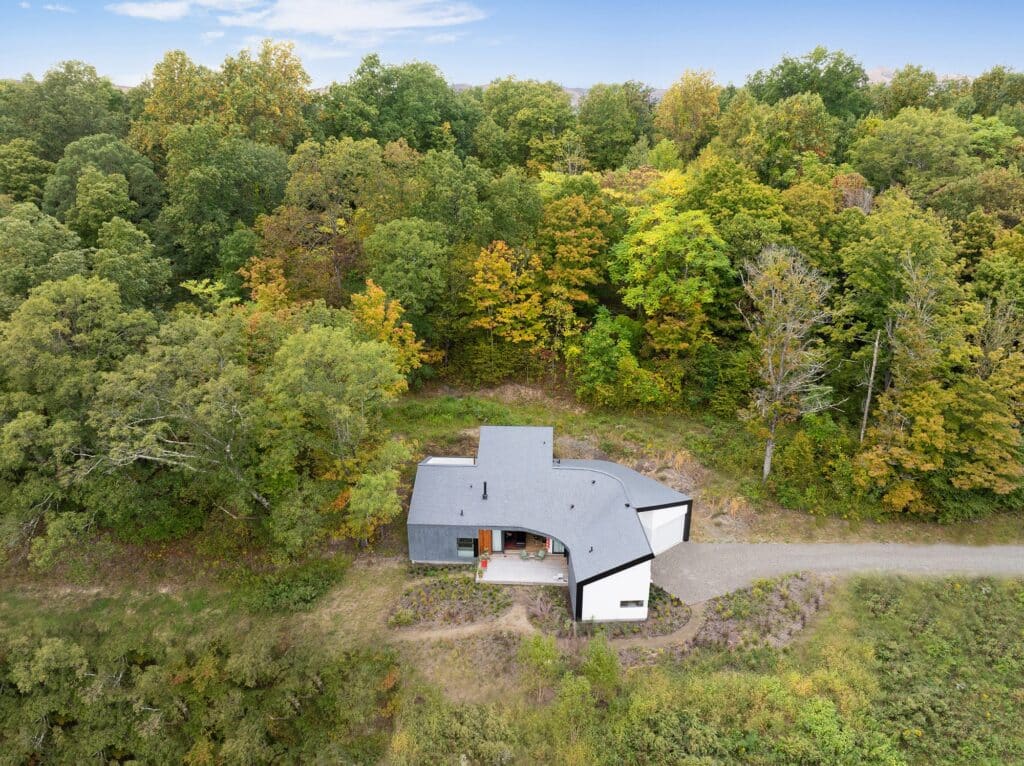 Exterior view of Miranda Chang&rsquo;s studio overlooking farmland and forested hillside in Germantown, New York.
