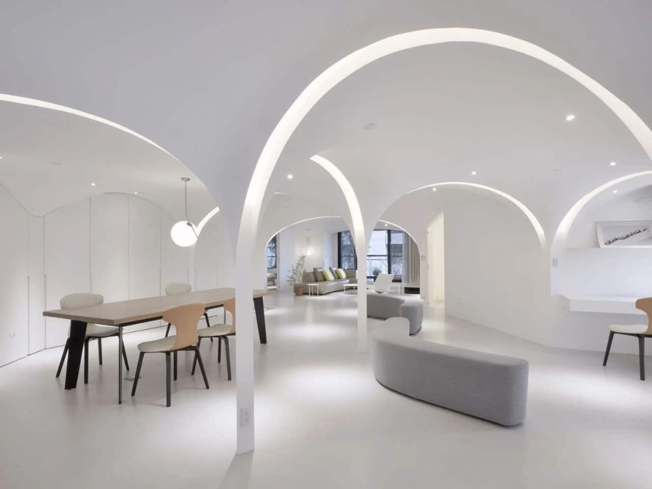 Redesigned urban apartment in Taichung featuring open-plan spaces, pentagonal layout, curved walls, natural light, ventilation, and acoustic differentiation.