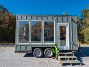 Exterior view of Dragon Tiny Homes mobile office showcasing its compact 16-foot structure with glass and wood panels.