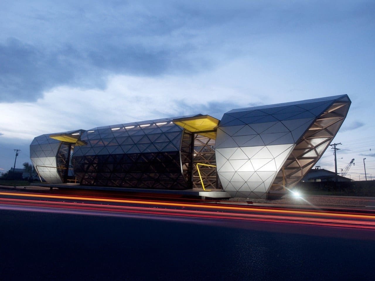 Exterior view of Belém Amazon Bus Station showing triangular steel structure, reflective glass panels, and accessibility features for all passengers.