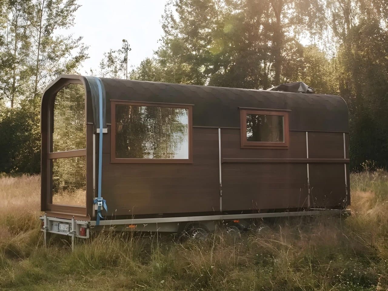 Nature Pod exterior view on a dual-axle trailer showing compact architectural design and mobility features for small-scale living.