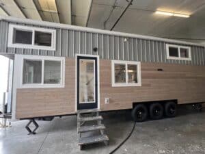 Exterior view of Big Freedom Tiny Homes showing mixed wood and metal materials