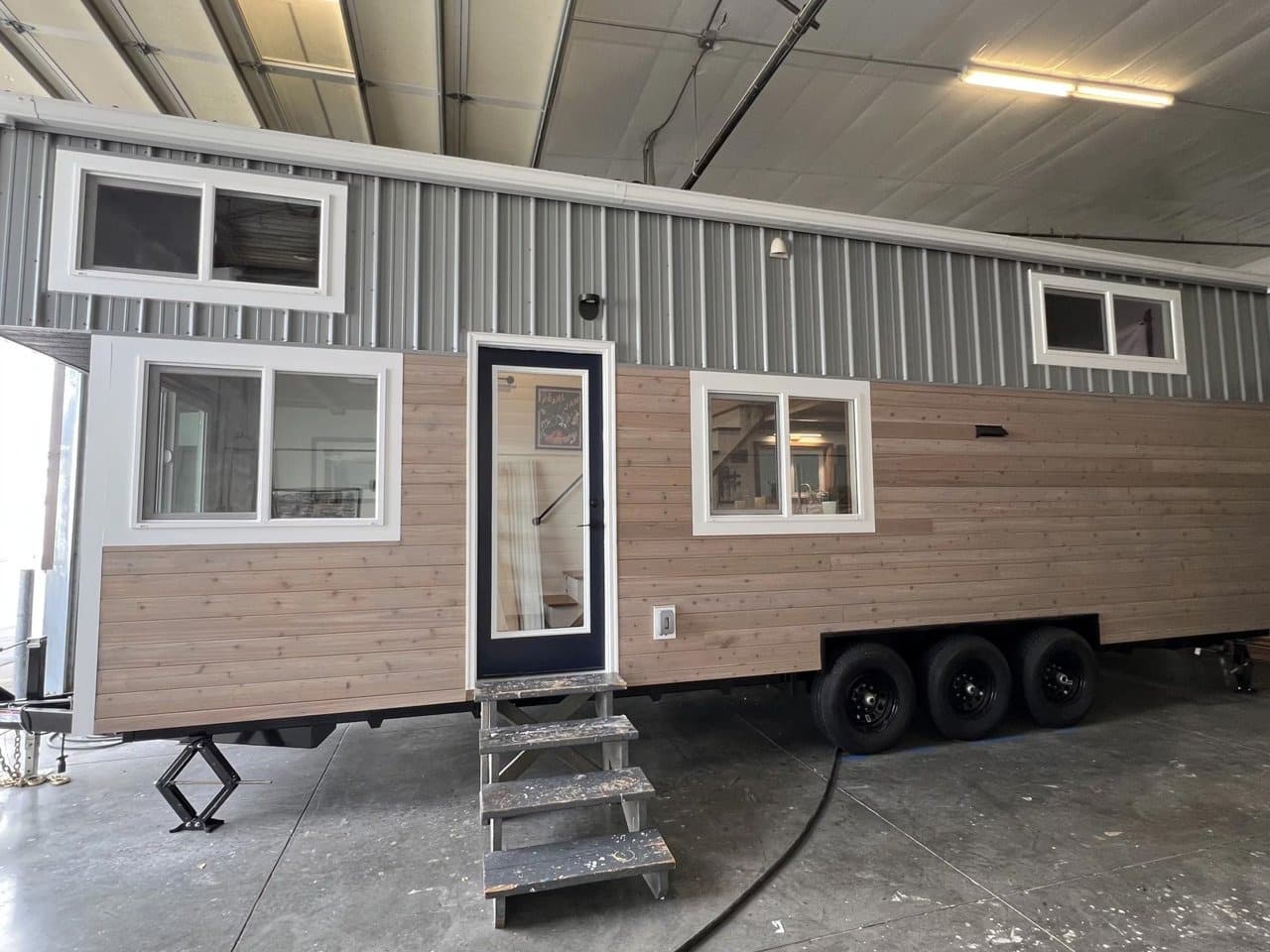 Exterior view of Big Freedom Tiny Homes showing mixed wood and metal materials