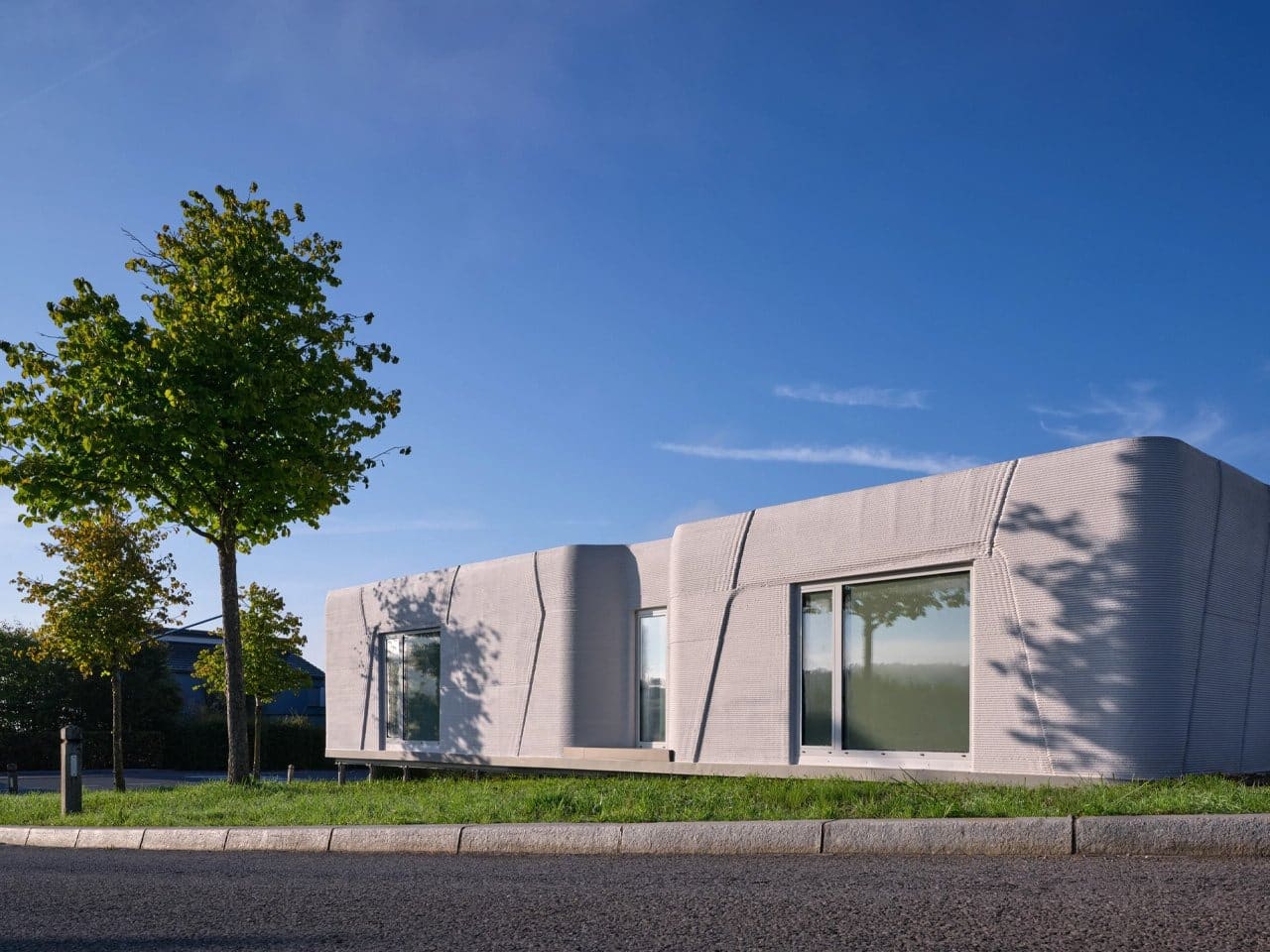 Tiny House Lux in Niederanven, Luxembourg, 3D-printed concrete residential building with sustainable design, compact urban layout, and energy-efficient features.