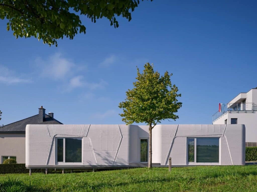 Tiny House Lux in Niederanven, Luxembourg, 3D-printed concrete residential building with sustainable design, compact urban layout, and energy-efficient features.