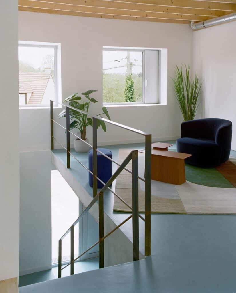 View of the original 1980s house structure with semi-buried ground floor and living spaces above