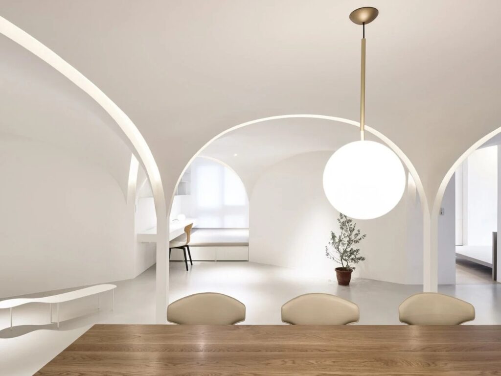 Redesigned urban apartment in Taichung featuring open-plan spaces, pentagonal layout, curved walls, natural light, ventilation, and acoustic differentiation.