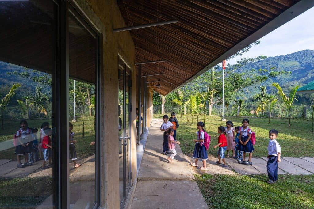 Nuoc Ui School classrooms constructed with rammed earth walls and bamboo roofs reflecting local material use.