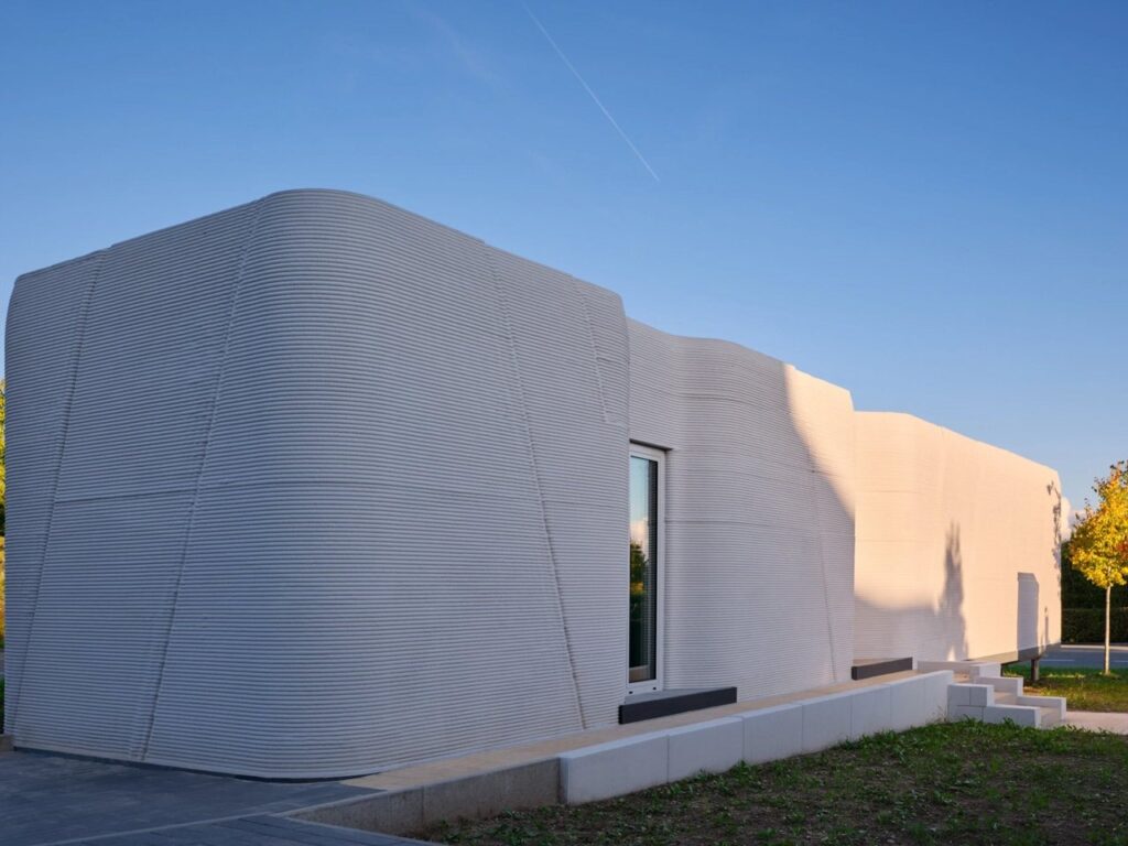 Tiny House Lux in Niederanven, Luxembourg, 3D-printed concrete residential building with sustainable design, compact urban layout, and energy-efficient features.