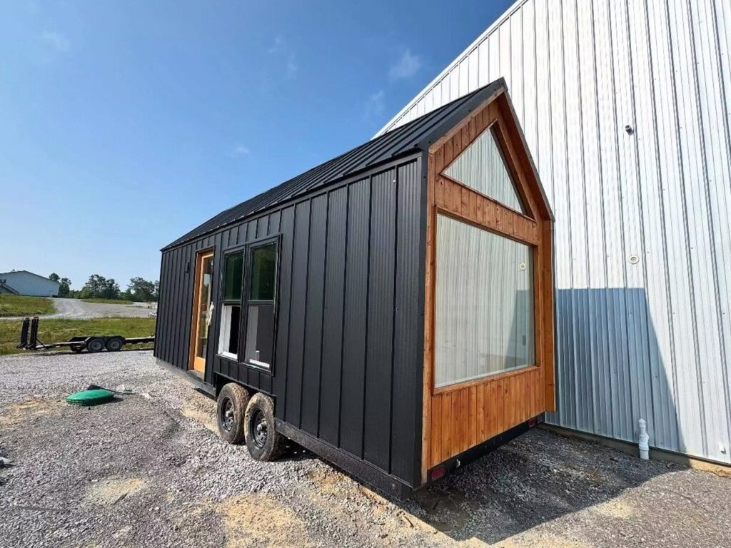 Exterior view of Weekender house with large windows and metal cladding
