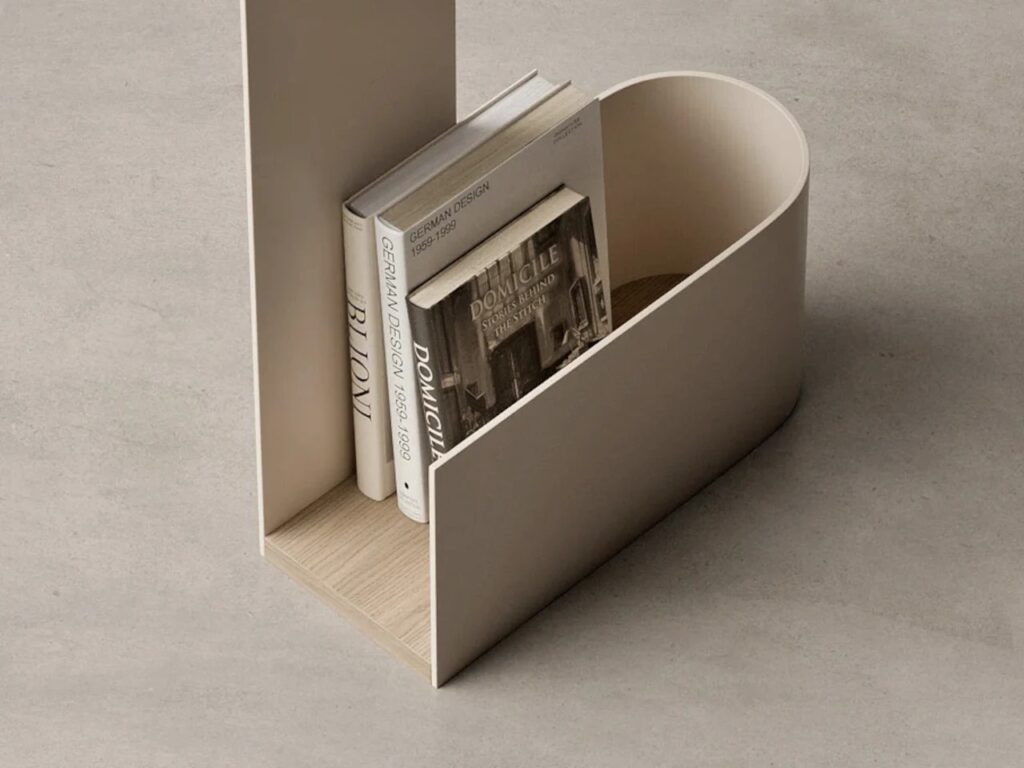 TWIST side table design combining ergonomic handle, circular tabletop opening, integrated storage, and balanced metal-wood materials, illustrating multifunctional and sculptural features in modern interior furniture.