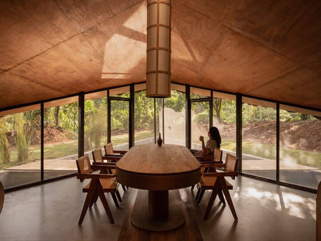 Overview of The Bridge House surrounded by dense forest in Karjat, India