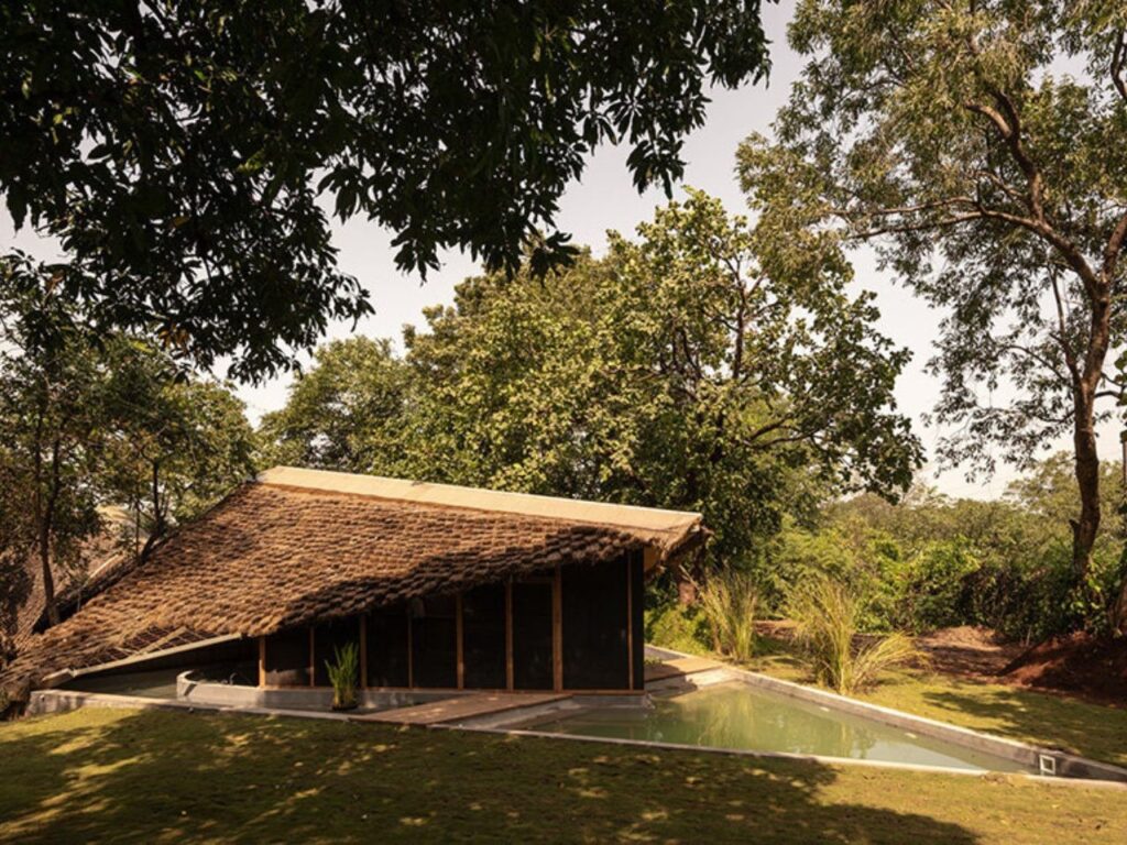 Overview of The Bridge House surrounded by dense forest in Karjat, India