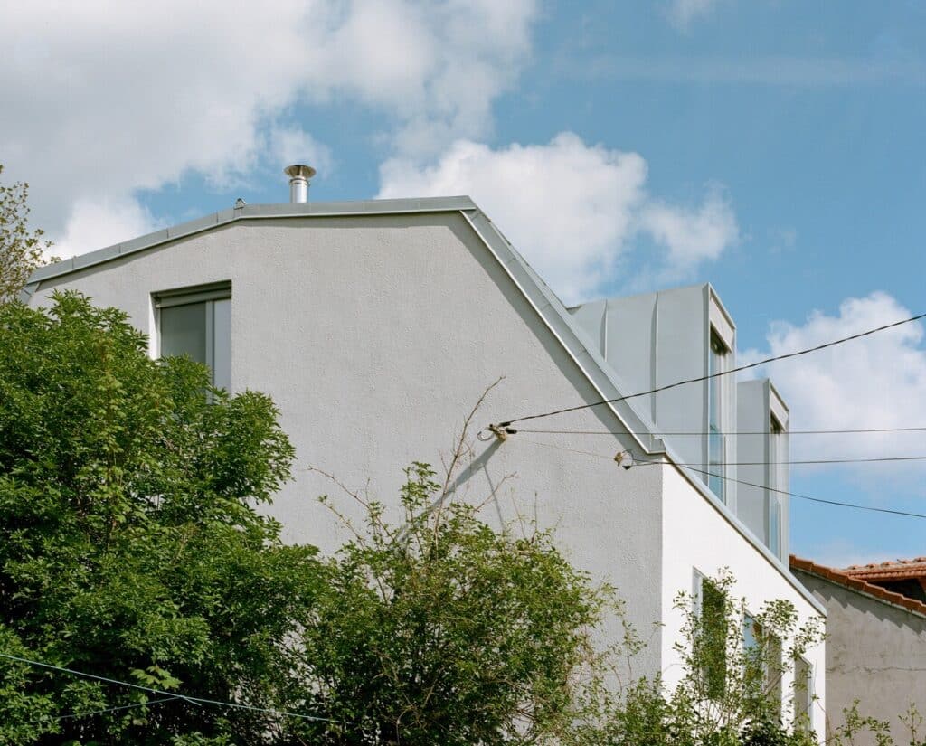 Comprehensive view of the renovated 1980s house showing sustainable upgrades, improved energy efficiency, open interior spaces, and enhanced natural lighting and ventilation